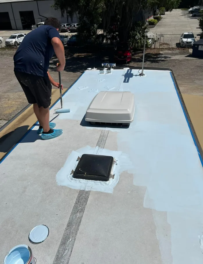 Applying roof sealant to an RV in Fellsmere, FL